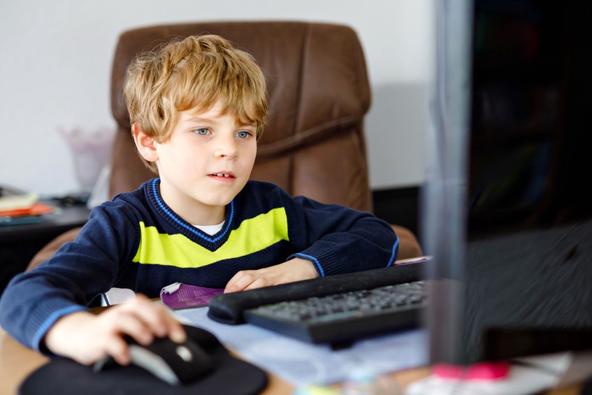 Boy using a computer at home.